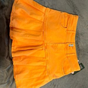 Size 6 skirts has no shorts under and it’s bright orange, new with tags
